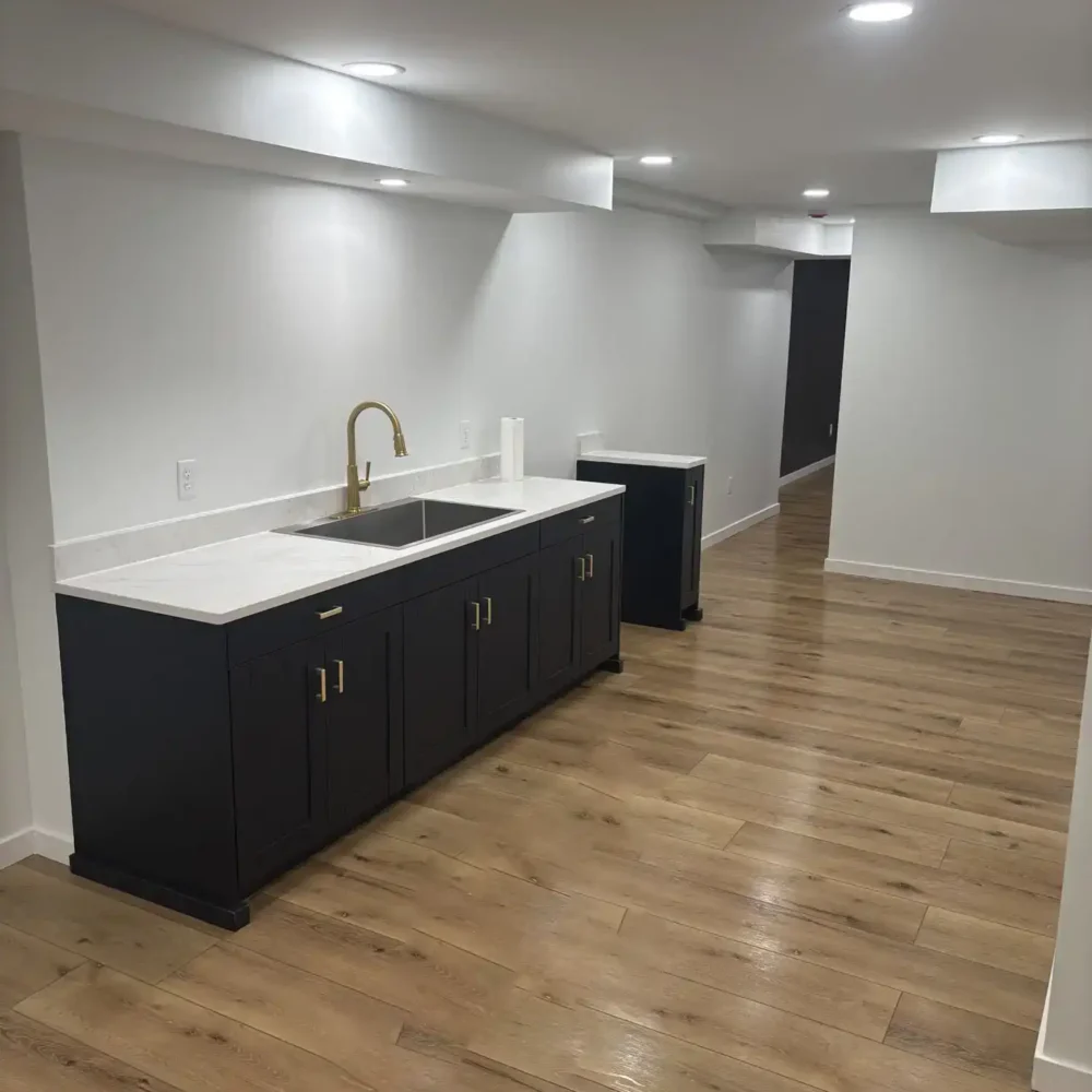 Remodeled Basement Area with Marble Countertops and Dark Wood Cabinetry